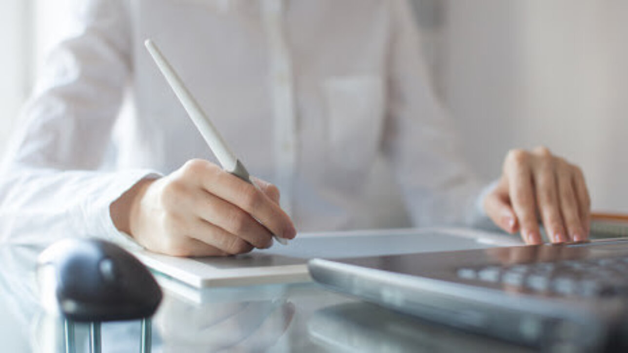 Female designer using graphics pad in office