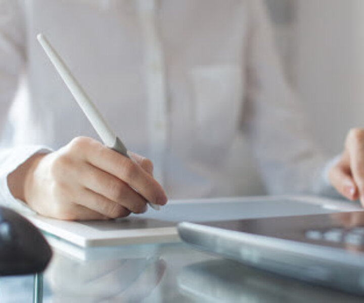 Female designer using graphics pad in office